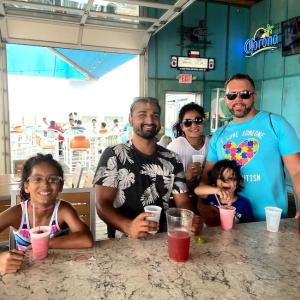 Matt Sheikh shown with his family at a restaurant.