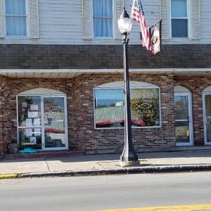 View of a street with a street lamp that has the American Flag on it