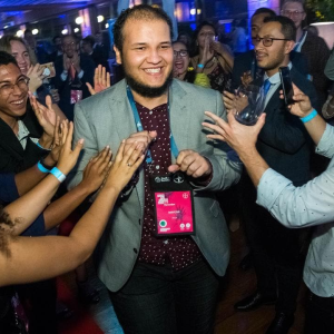 Maycon being cheered by a group of people around them