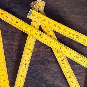 measuring tapes on wooden background