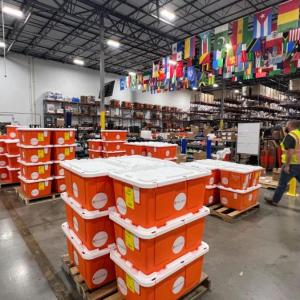 orange tubs of medicine in a warehouse