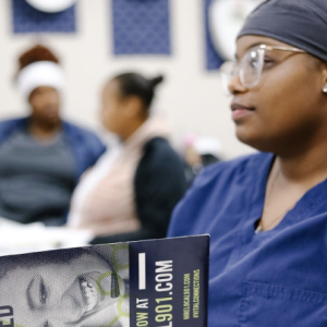 A medical professional holding a book