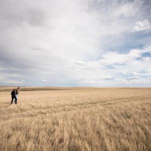 Person walking across a field of grasslands. © WWF-US / Clay Bolt