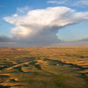 Aerial photo of a grassland landscape with sky and clouds. ©2018 Chris Boyer--Kestrel Aerial Services