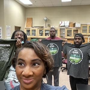 Ebony taking a selfie with some Alabama A&M University students after sharing some Rayonier Tshirts.
