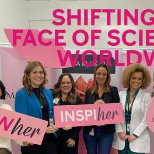 group photo of women holding signs. Reads: "Shifting the face of science worldwide"