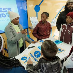 Students with scientists in the Curiosity Cube