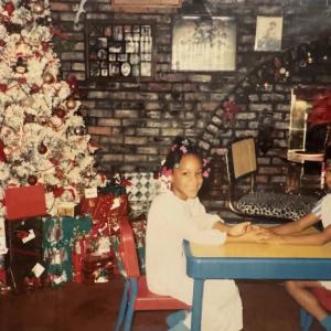 Meshawn Woods and LeShawn Parrish as kids by a christmas tree.