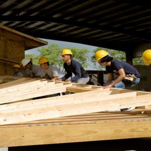 Construction workers build a MiCASiTA home. 