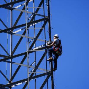 Worker climbing tower