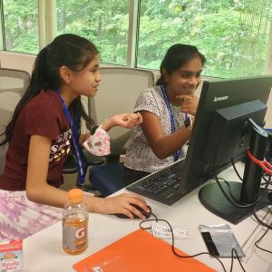 two students on a computer together 