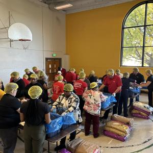 Volunteers shown packing meals for people in need.