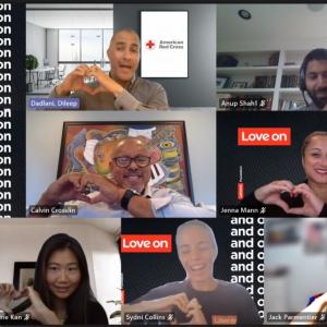 Lenovo employees make hearts with their fingers on a video call