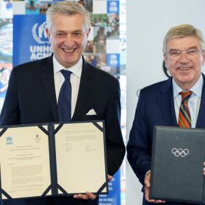 two people holding official signed documents