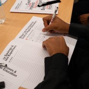 Student writing in a notebook.