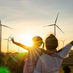Parent and child looking windfarm