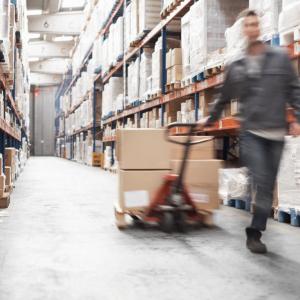 Worker pulling boxes in a warehouse