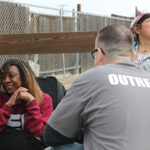 Volunteer speaking with woman in chair