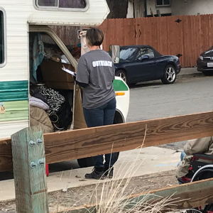 Volunteer standing at door of motorhome