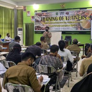 room full of people sitting at desks with screen at front of room