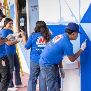 group of students painting building