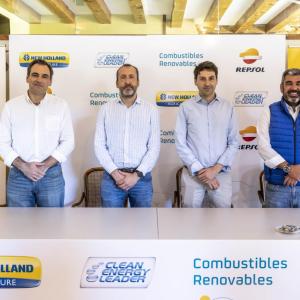 Four people standing at a booth with NH and Repsol logos