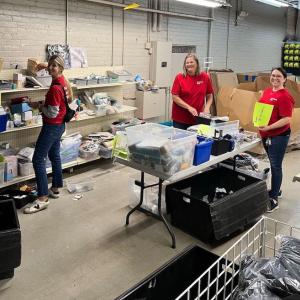 KeyBank volunteers gathering clothes and shoes for kids.