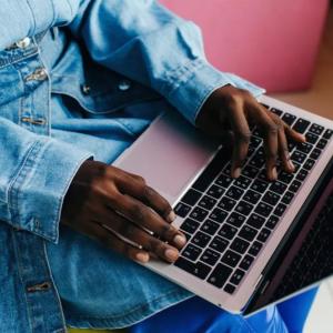 A person typing on a laptop.