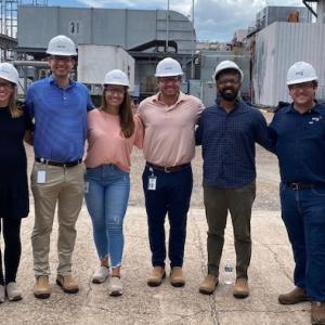 NRG Interns shown on a worksite wearing hardhats.