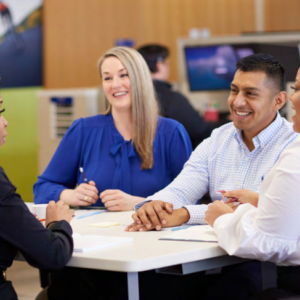 Four people seated around a table.