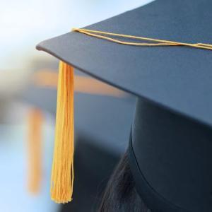 Graduates mitre shown with gold tassel.