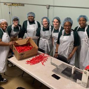 A group of people helping to package food