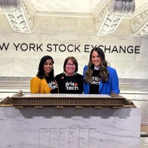 Three people posed at a podium. "NEW YORK STOCK EXCHANGE' behind them.
