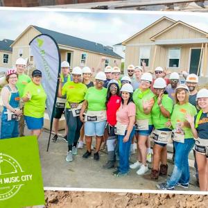 A group of volunteers posed outside a home being built.