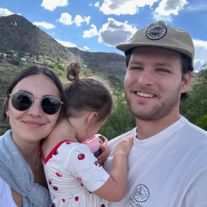 Natalie shown with her husband and daughter.