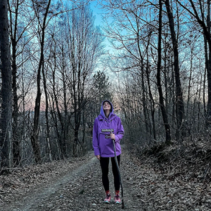 Natasa walking in a forest.