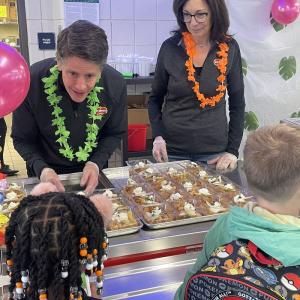 Del Monte Foods team members John Fusco and Sheri Caplan volunteer to hand out samples of a new school recipe using baked Del Monte® sliced pears at Pittsburgh Minadeo PreK-5.