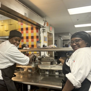 two people working in kitchen