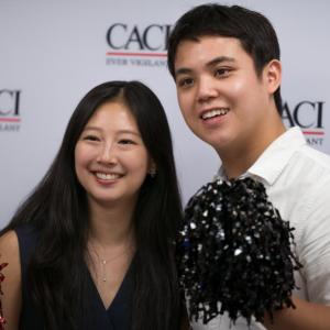 Two people at CACI's National Intern Day celebration