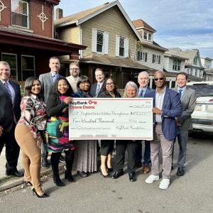 KeyBank and NeighborWorks Team shown with a check for $400,000.