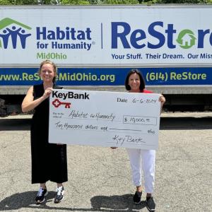 KeyBank volunteer shown with Habitat for Humanity volunteer with a $20,000 grant check.