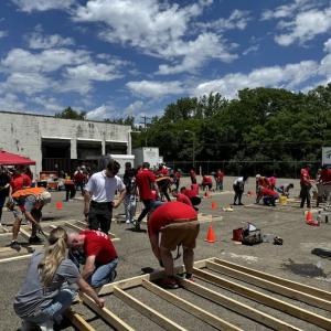 KeyBank volunteers shown building a frame for a home.