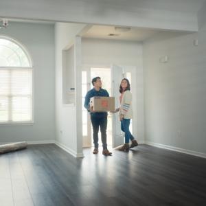 A young couple are shown moving into their new home.