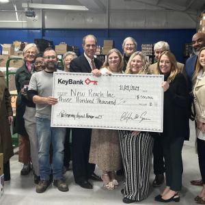 New Reach and KeyBank team shown with grant check.