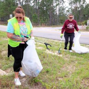 Volunteers pick up trash at AEG Presents and Propellers beach clean up.