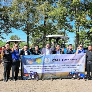 Group holding up a banner at New Holland Day celebration