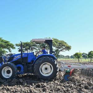 Blue tractor being used in a field