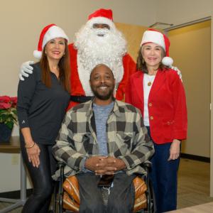 Entergy customer posing for picture with Santa and Entergy officials