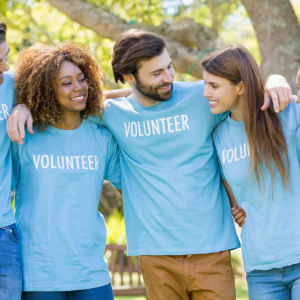 a group of volunteers wearing green shirts that say volunteer 
