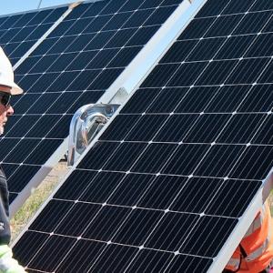 workers near a solar panel